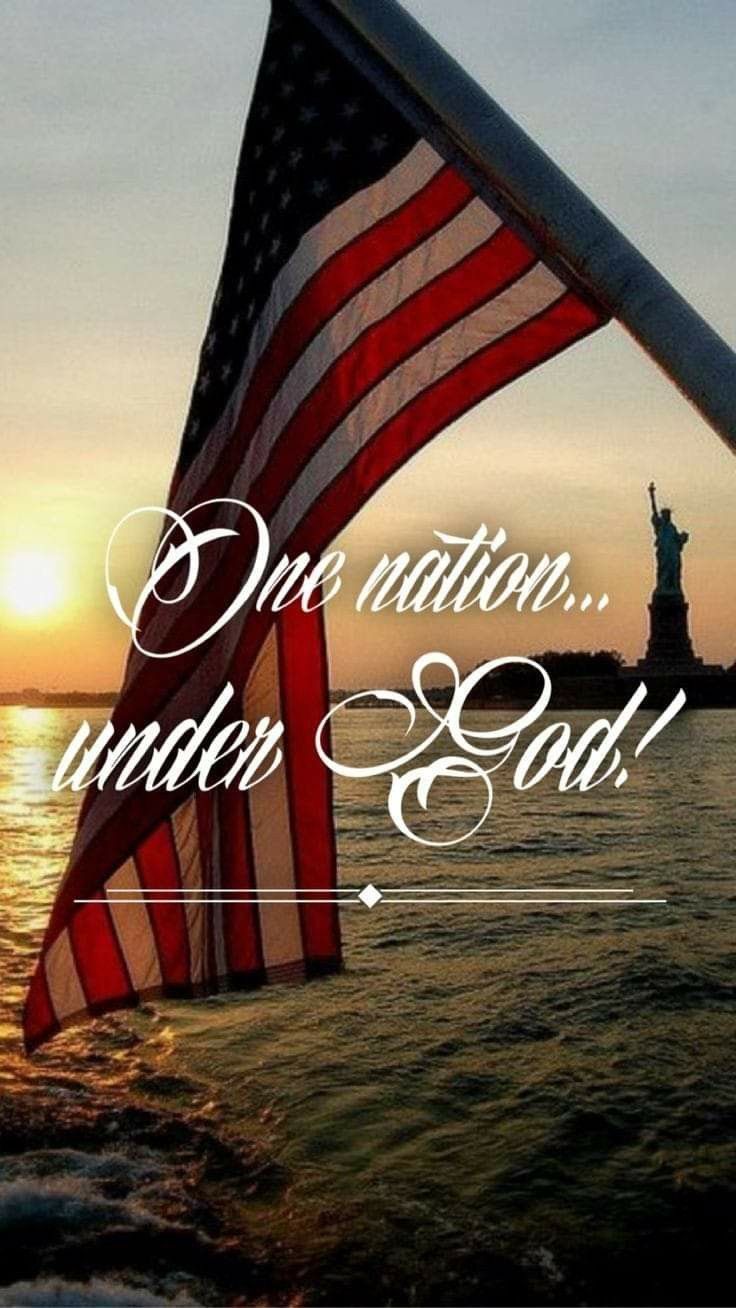 An American flag waving proudly against a bright blue sky with wispy white clouds, featuring the text overlay One Nation Under God.
